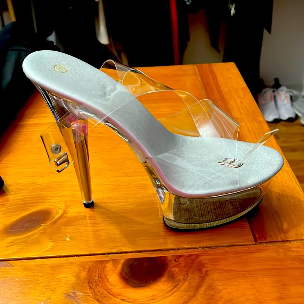 Clear platforms with ankle straps. never worn. New in box.